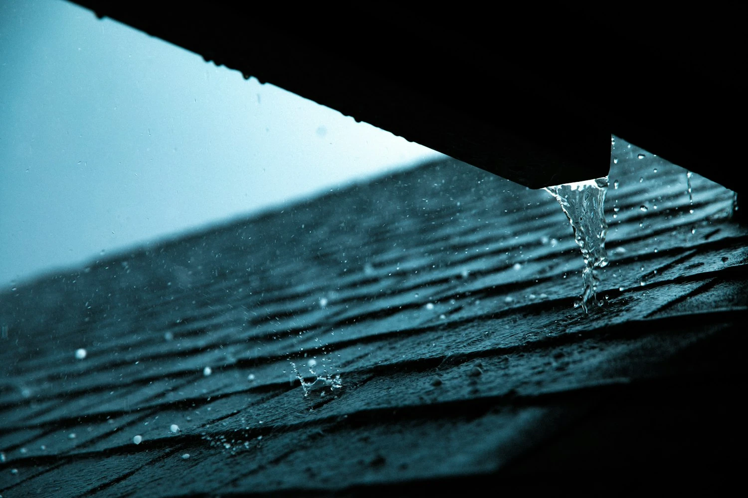 Rain falling along the roof and gutter of an Alabama property